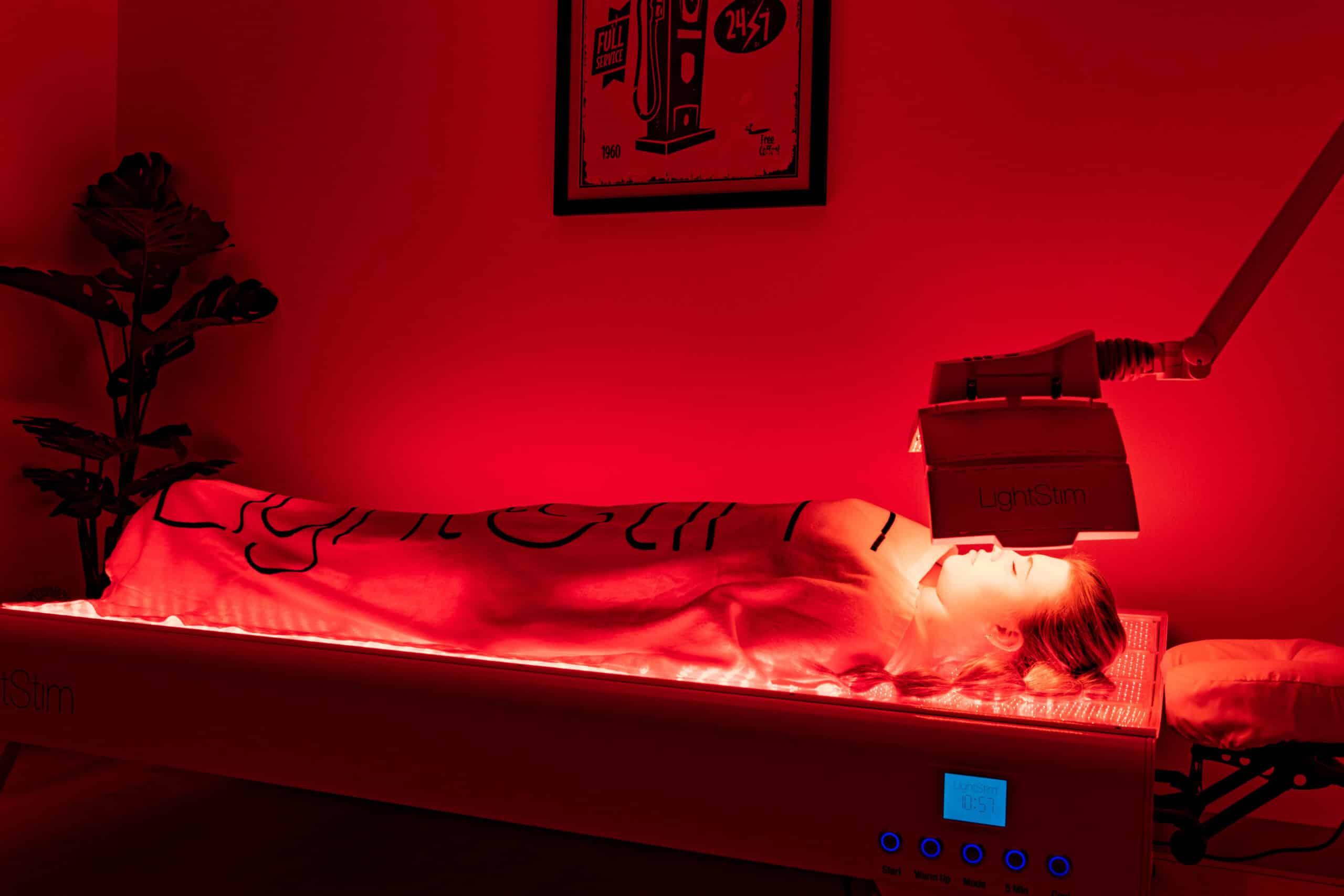 Woman on Light Stim bed for red-light therapy at Ascent Adaptation and Regeneration